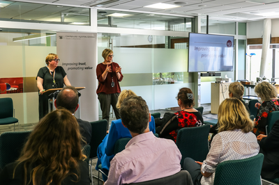 Photo of two staff presenting at an event during 2022
